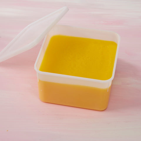 2L tub of pure New Zealand ghee, set smooth and golden, with the lid resting beside it