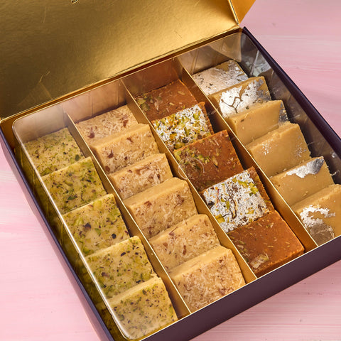 Pista, almond, besan and khoya burfi squares in a box