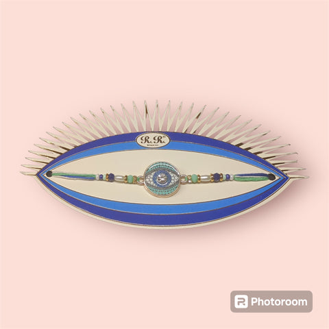 Blue evil eye rakhi on red thread