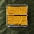 Besan Burfi in a clear box