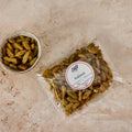 A bowl of sultanas beside the 250g Pure Desi pack