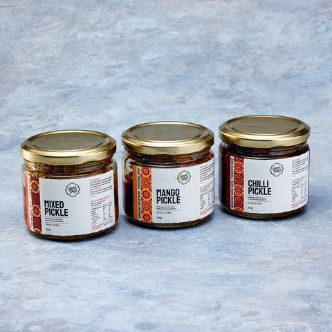Pure Desi mixed, mango and chilli pickle jars side by side