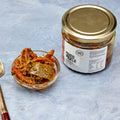 Pure Desi mixed pickle with carrot, mango and chilli pieces in a bowl beside the jar