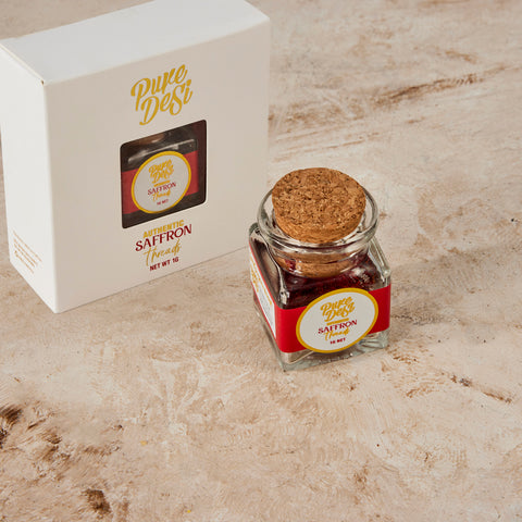 Pure Desi saffron jar in front of its white gold-foiled gift box