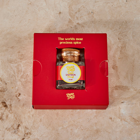 Pure Desi saffron jar seated in its red gift tray, printed The world's most precious spice
