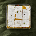 Roasted Dry Fruit Burfi in a clear box