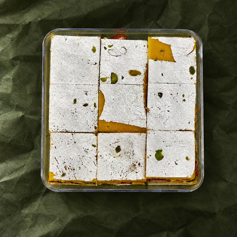 Roasted Dry Fruit Burfi in a clear box