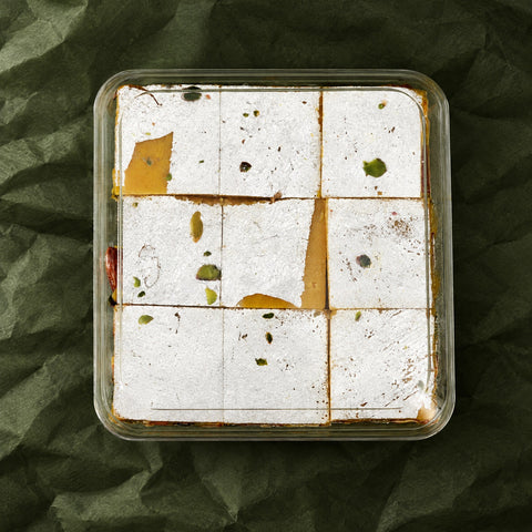 Roasted Dry Fruit Burfi in a clear box