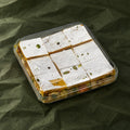 Roasted Dry Fruit Burfi in a clear box
