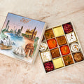 Pure Desi Bring India Home sweet box open beside its watercolour lid of Sydney Harbour and Delhi landmarks